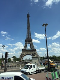 a white van parked in front of the eiffel tower